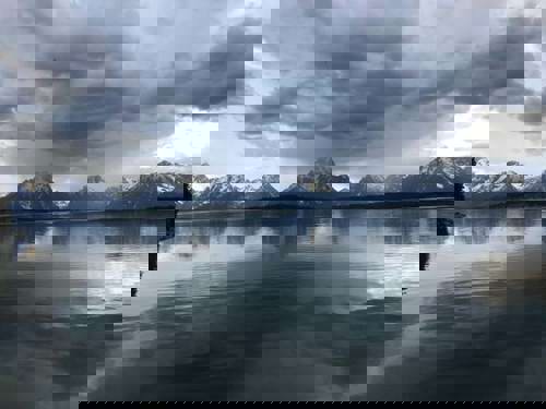 The calm lake and icy peaks of Grand Teton National Park