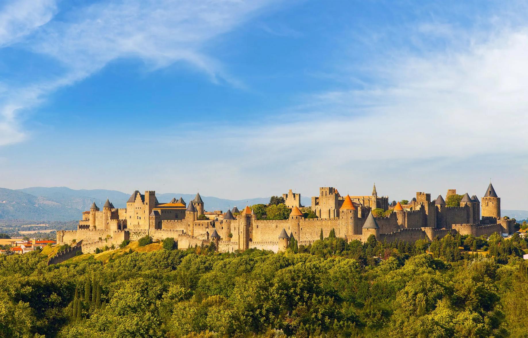 Wide view of the medieval Cité de Carcassonne fortress in France, surrounded by its historic stone walls and towers