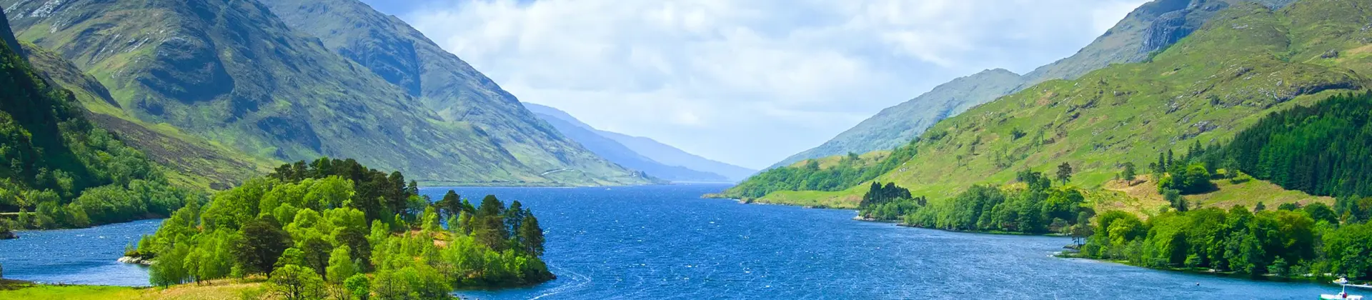 Zoomed out view of Glenfinnan Monument, Loch Shiel and surrounding mountains Scotland