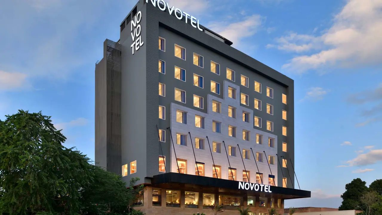 Exterior of Novotel Jodhpur, a modern grey and white building with large windows and a landscaped entrance