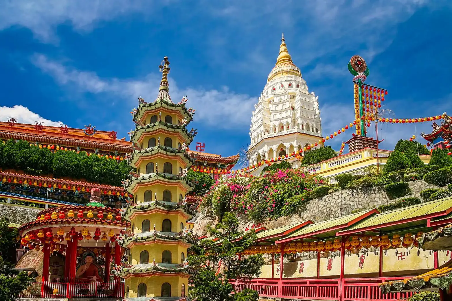 Kek Lok Si Temple in Penang, Malaysia, with its tiered pagoda and ornate rooftops under a bright blue sky