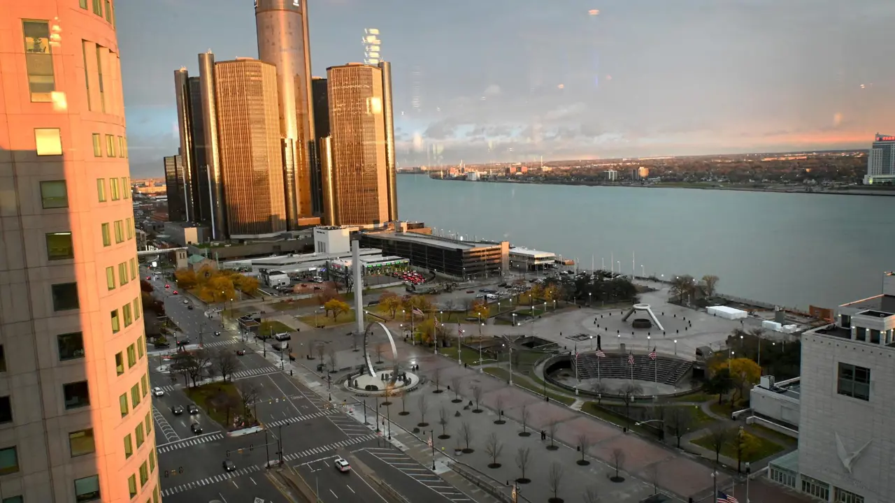 View from Fort Pontchartrain hotel, overlooking downtown Detroit with the GM Renaissance Center, Hart Plaza, and the Detroit River, with Windsor, Canada visible across the water