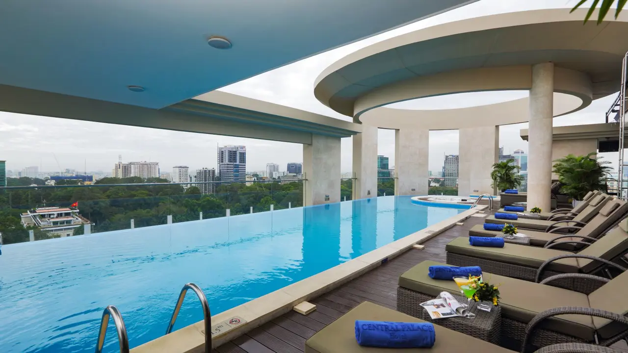 Rooftop pool area at Central Palace Hotel, Ho Chi Minh City, with a sleek swimming pool, sun loungers, and panoramic views of the city skyline