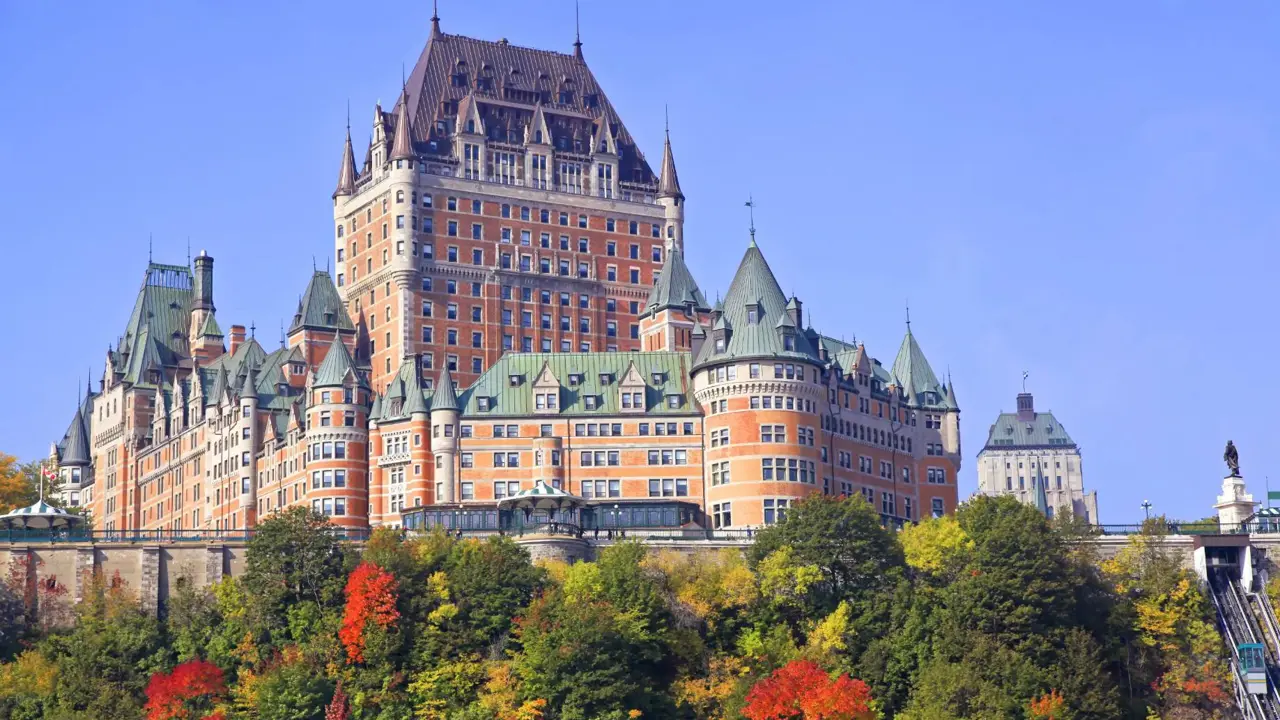 The Château Frontenac, a grand historic hotel in Quebec City, Canada, with its distinctive steep green roofs and turrets against a clear sky