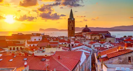 View of Alghero with the sea in the background at sunset
