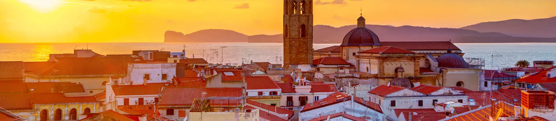 View of Alghero with the sea in the background at sunset