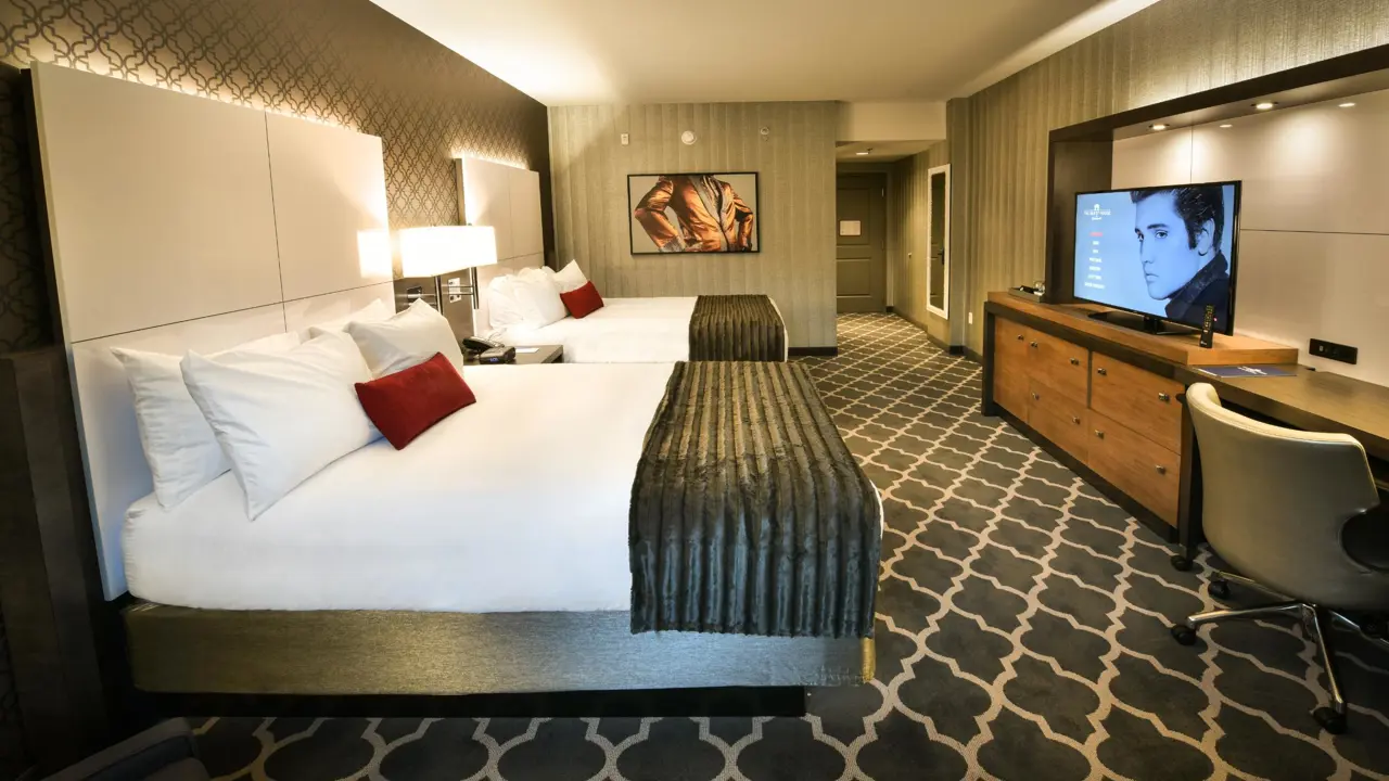Comfortable double queen room at The Guest House at Graceland, decorated in warm tones with modern amenities and Elvis artwork