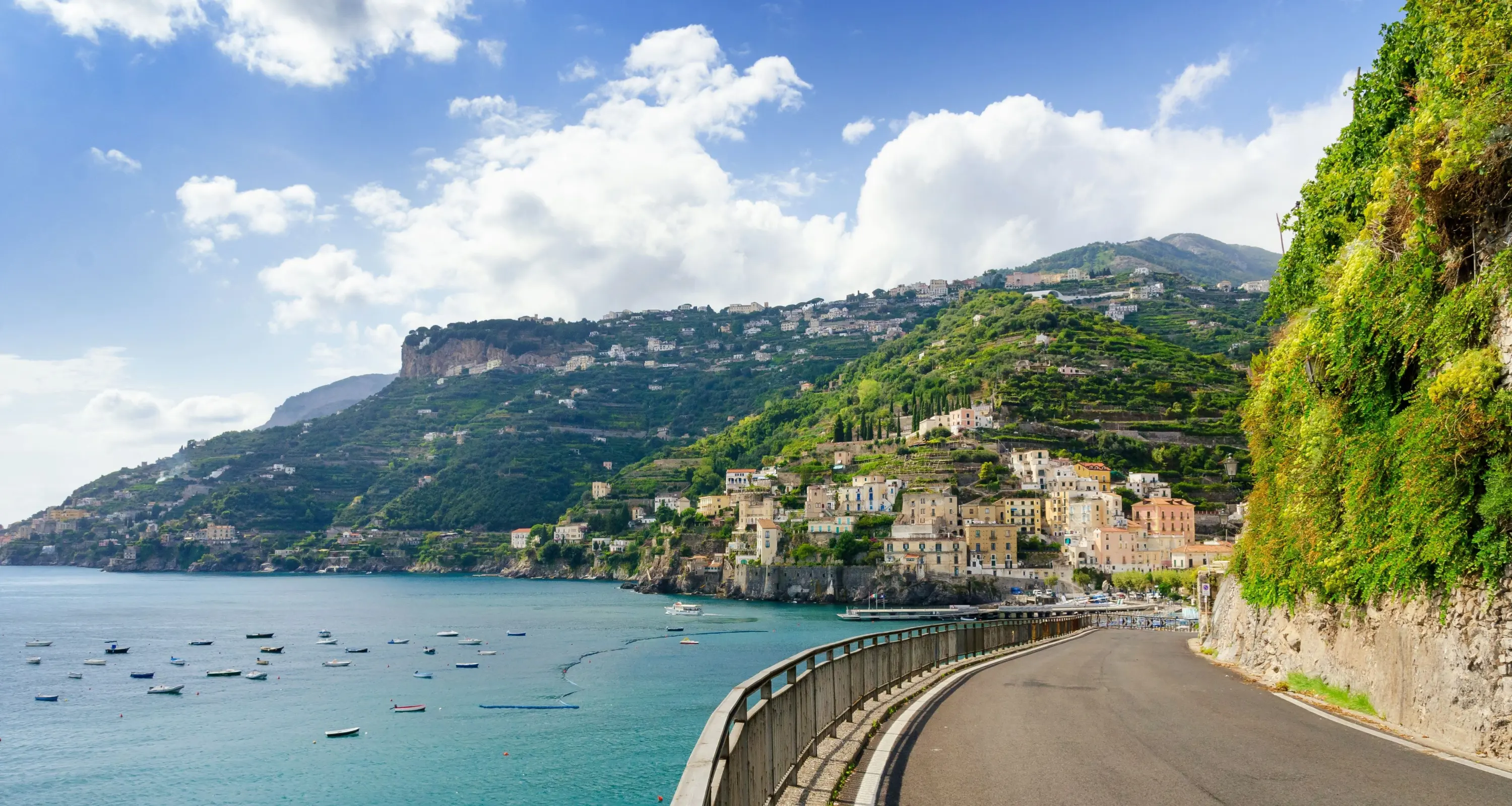 Road On The Amalfi Drive, showing the sea with boats and a mountain