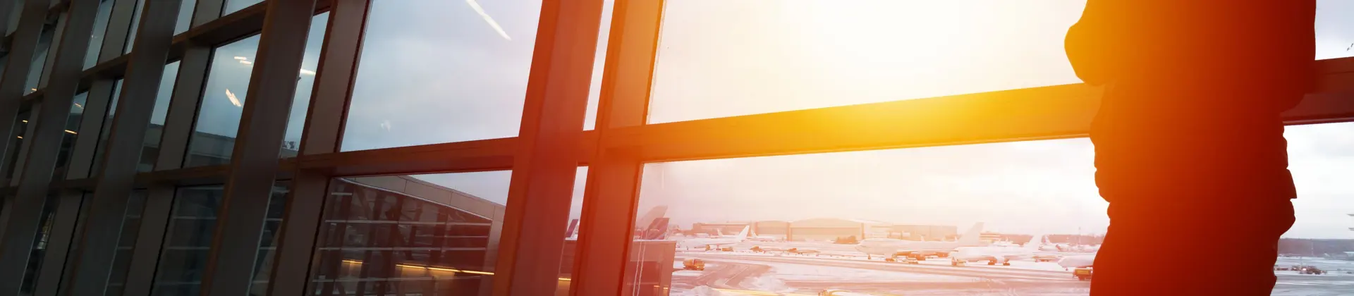 Person looking out the window in an airport