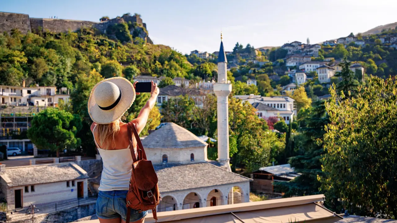 Woman taking a photo of a mosque in Gjirokastër