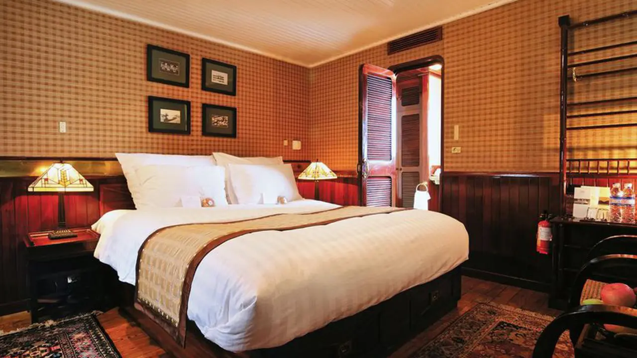 Cosy cabin bedroom on the Emeraude Classic Cruise featuring wooden furnishings, crisp white bedding and soft lighting