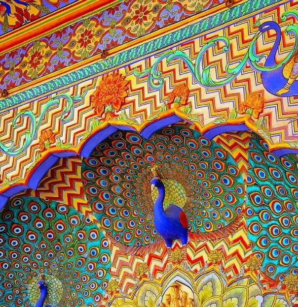 Ornate Peacock Gate at Jaipur City Palace, India, featuring intricate colourful artwork and detailed carvings inspired by peacock feathers and traditional Rajasthani design
