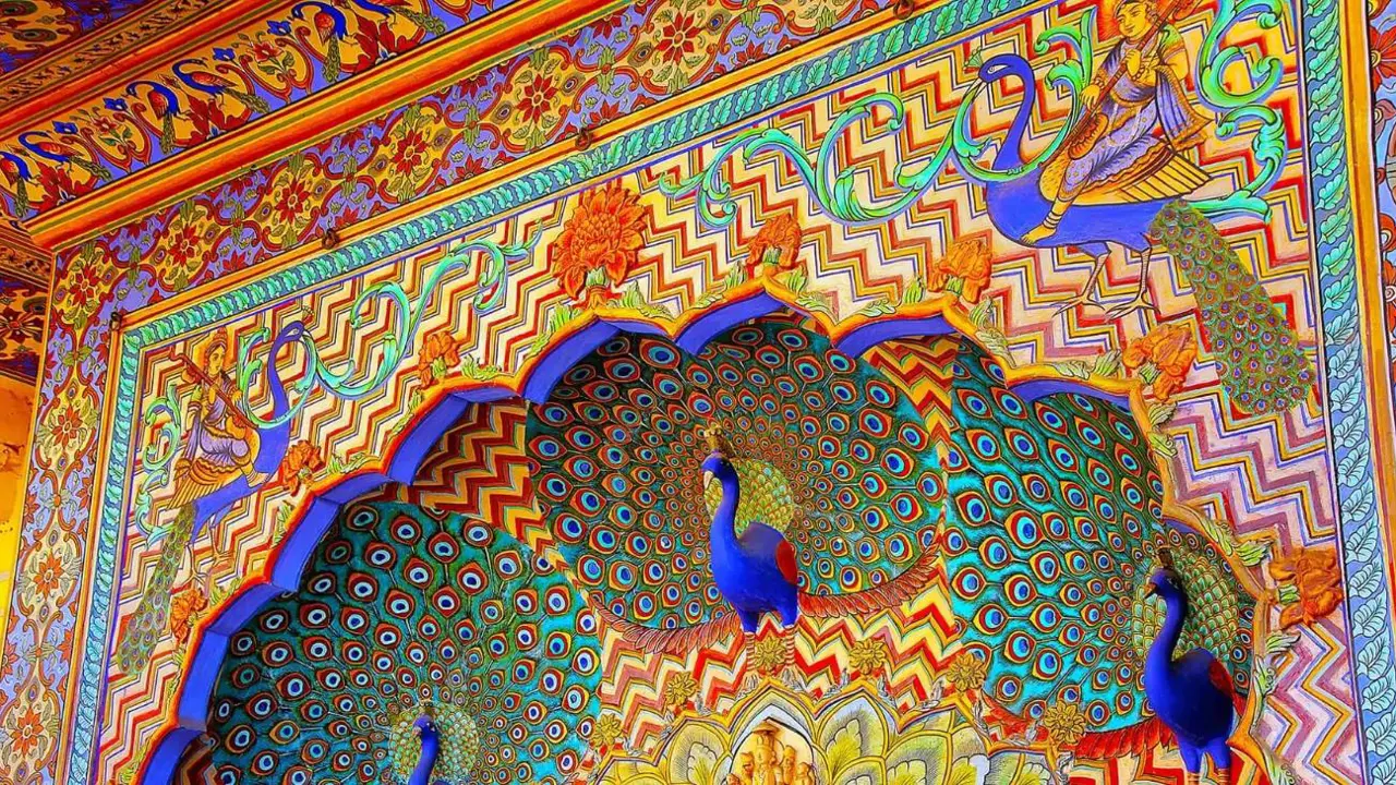 Ornate Peacock Gate at Jaipur City Palace, India, featuring intricate colourful artwork and detailed carvings inspired by peacock feathers and traditional Rajasthani design