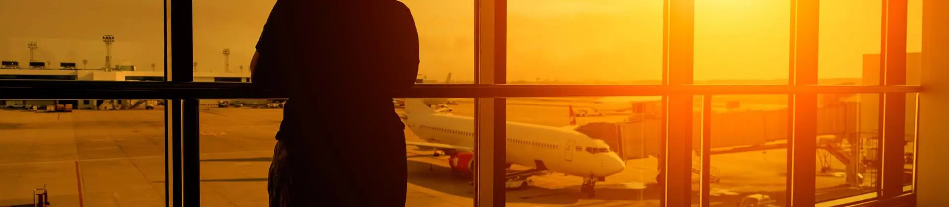 Person looking out the window in an airport