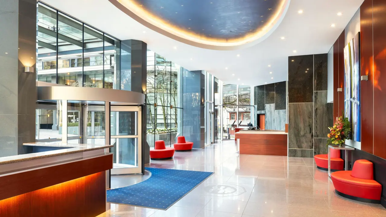 The reception area of Sheraton Vancouver Wall Centre hotel, featuring a modern desk, warm lighting, and sleek contemporary design