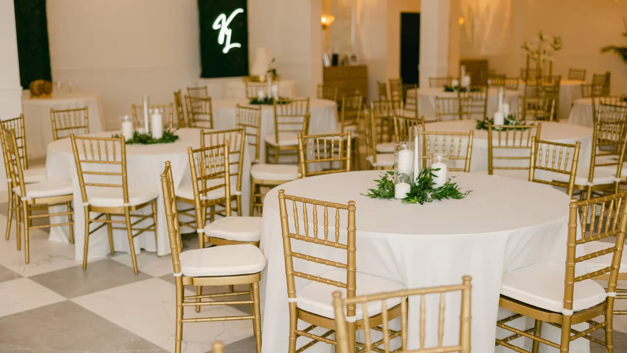 Elegant dining room at Gulf Hills Resort in Ocean Springs, featuring neatly arranged tables with white linen, classic wooden chairs, warm ambient lighting