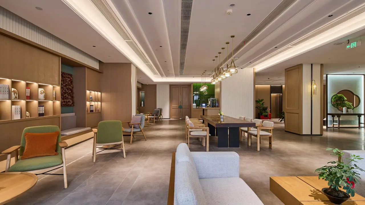 Spacious hotel lobby with marble flooring, warm lighting and stylish seating at the Youngor Central Hotel in Suzhou, China