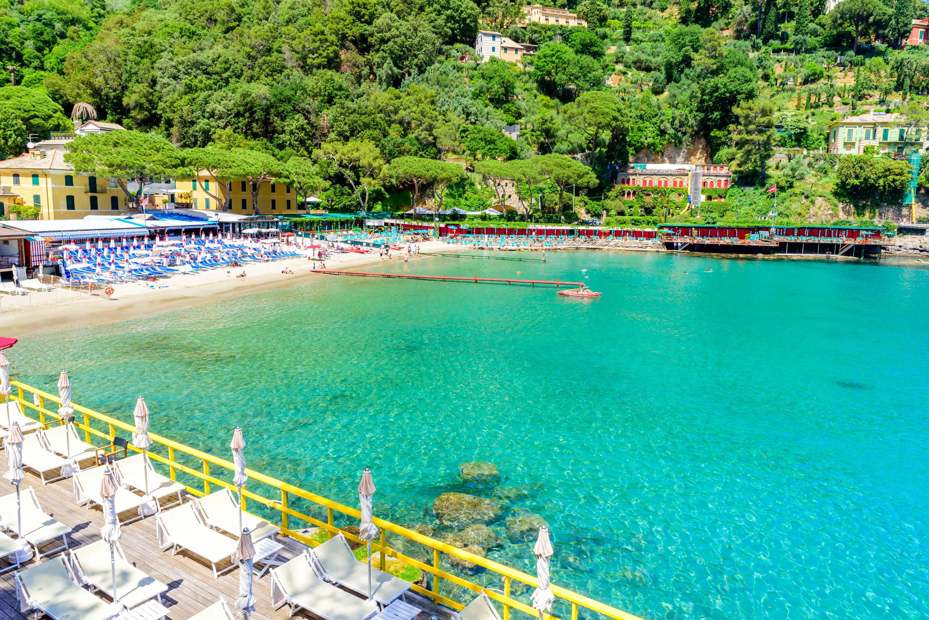 Paraggi Beach in Portofino showing sunloungers lined up and the blue, clear water