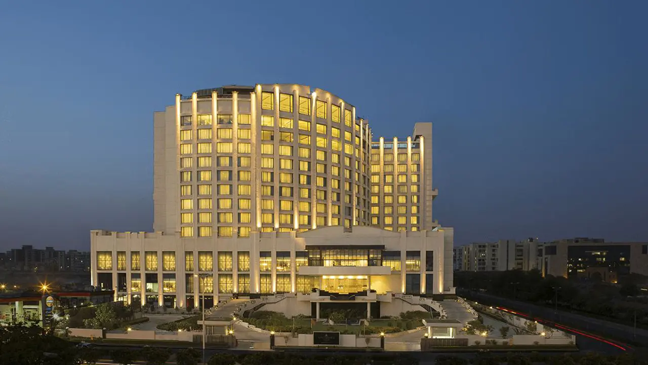 The illuminated exterior of WelcomHotel by ITC in Dwarka with its tiered architecture at dusk