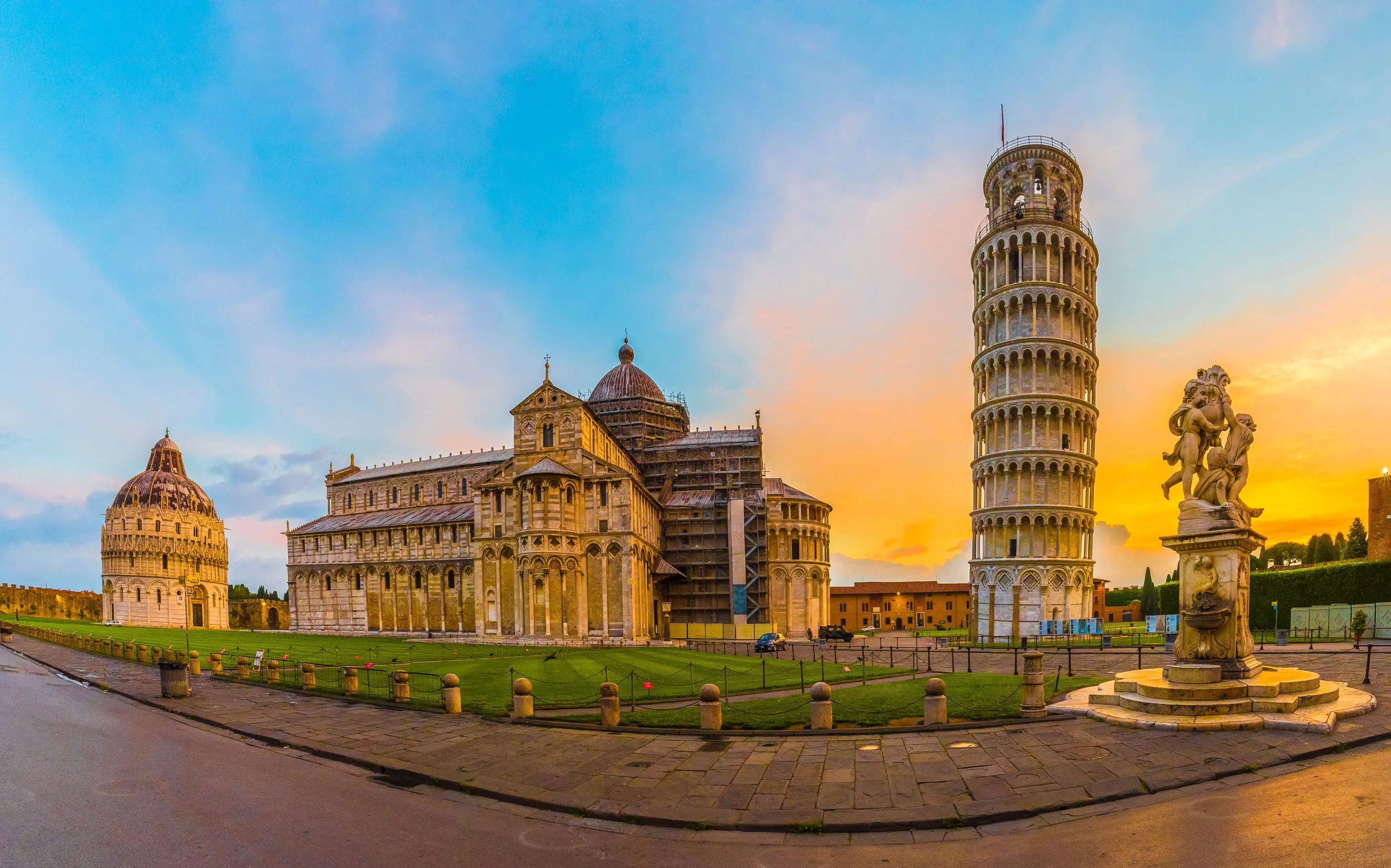 View of the Tower of Pisa and surrounding monuments at sunset 