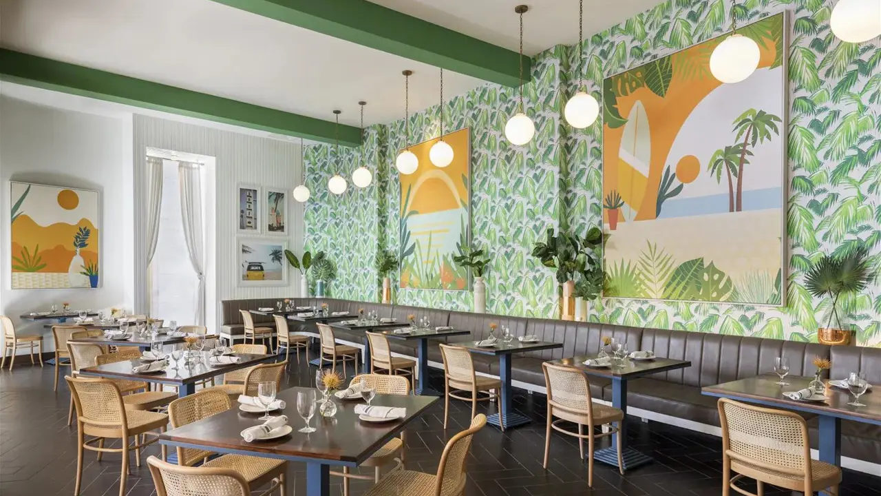 Contemporary dining area at the Riviera Resort & Spa, Palm Springs, featuring a fresh green and white colour scheme, neatly arranged tables, and bright, airy surroundings